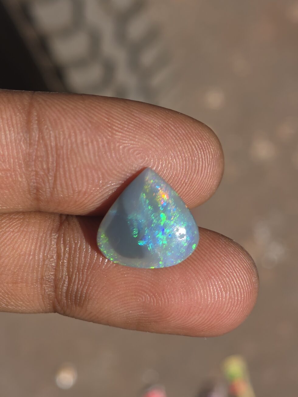Natural Australian opal pear shape cabochon gemstone with blue green fire