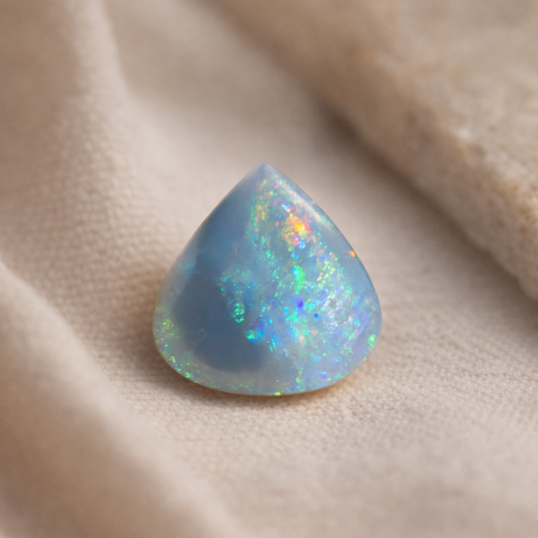 Natural Australian opal pear shape cabochon gemstone with blue green fire